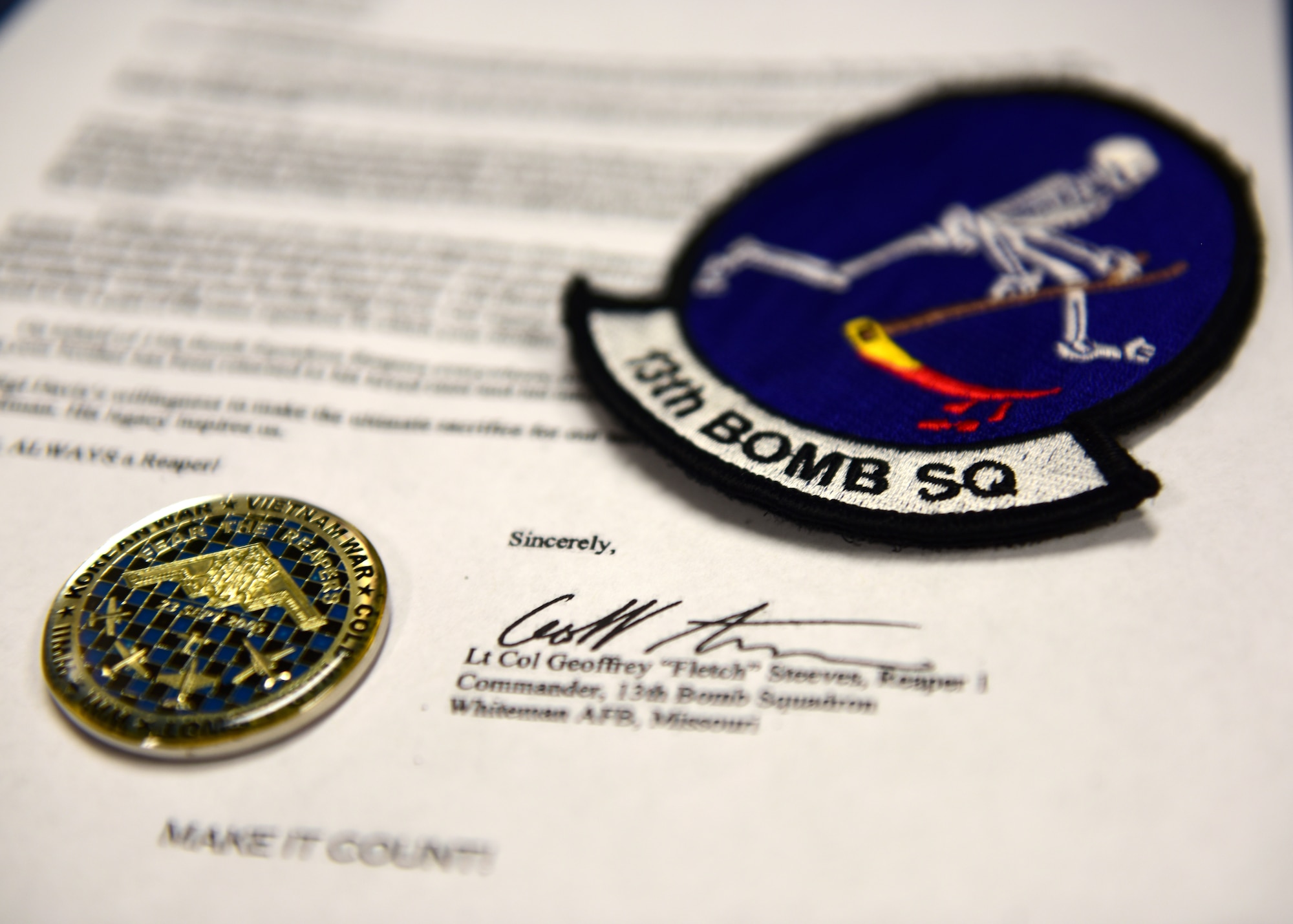 The current 13th Bomb Squadron patch and coin, along with a copy of the letter that was presented to the family of Army Air Force Staff Sgt. Roy Davis, a service member who was finally returned home after more than 70 years of being missing in action. Davis, a member of the 13th Bombardment Squadron of the 3rd Bombardment Group during World War II, received a proper burial with full military honors on June 23, 2018, in Ashby, Massachusetts.