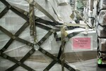 A completed pallet with color-coded placard identifies the shipment as uniforms for the Iraqi security forces.