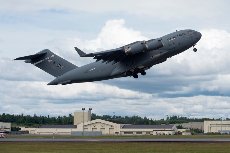 A C-17 Globemaster III with the 176th Wing takes off during the Arctic Thunder Open House Special Needs and Department of Defense Family Day at Joint Base Elmendorf-Richardson, Alaska, June 29, 2018. During the biennial open house, the base opens its gates to the public and hosts multiple performers including the U.S. Air Force Thunderbirds, JB Elmendorf-Richardson Joint Forces Demonstration and the U.S. Air Force F-22 Raptor Demonstration Team. (U.S. Air Force photo by Alejandro Peña)