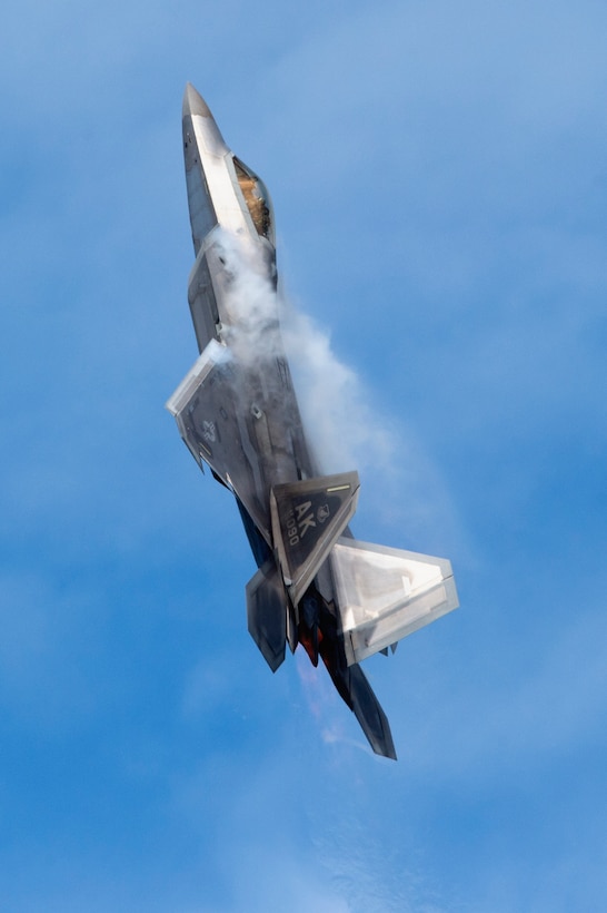 An F-22 Raptor piloted by a member of the Air Combat Command F-22 Demonstration Team performs aerial maneuvers during the Arctic Thunder Open House at Joint Base Elmendorf-Richardson, Alaska, June 30, 2018. This biennial event is one of the largest in the state and one of the premier aerial demonstrations in the world. The event featured multiple performers and ground acts to include the JB Elmendorf-Richardson joint forces, U.S. Air Force F-22 and U.S. Air Force Thunderbirds demonstrations teams, June 30-July 1. (U.S. Air Force photo by Alejandro Peña)