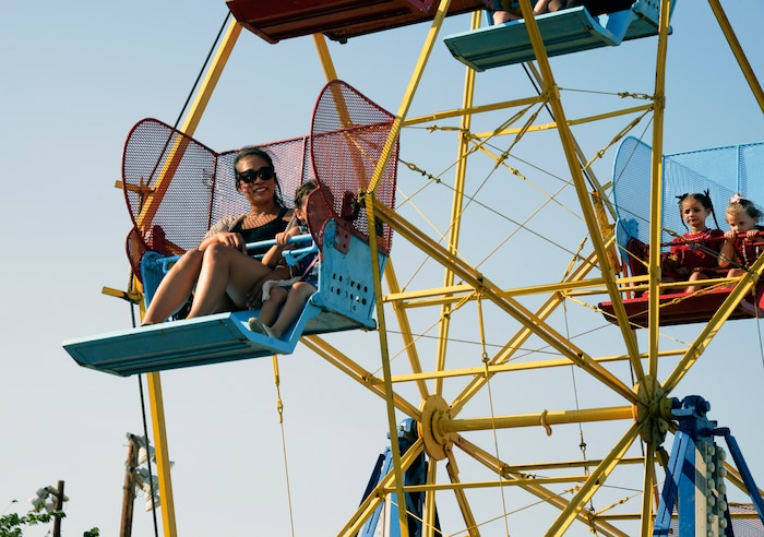 A mother and daughter ride the Ferris wheel at the carnival area of the Summer Bash at Wings Field, July 4. More than 2,500 people attended the annual summer event hosted by the 412th Force Support Squadron. (U.S. Air Force photo by Laura Motes)
