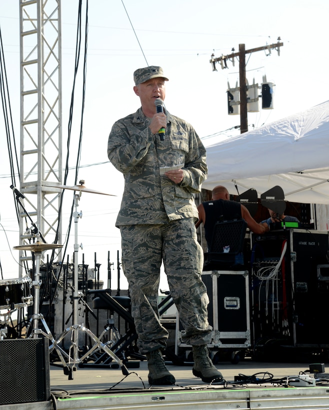 The 412th Test Wing vice commander, Col. Kirk Reagan, speaks to the crowd during the open ceremony at Wings Field, July4. During his remarks at the Summer Bash, Reagan remarked about the "great family environment" that exists at Edwards and that his family is proud to be back after several years away. (U.S. Air Force photo by Laura Motes)