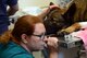 After anesthetizing MWD Aruba for his crown procedure, Tinker Veterinarian Dr. Heather Cameron watches the machines monitoring his vitals to assure he handles the anesthesia well.