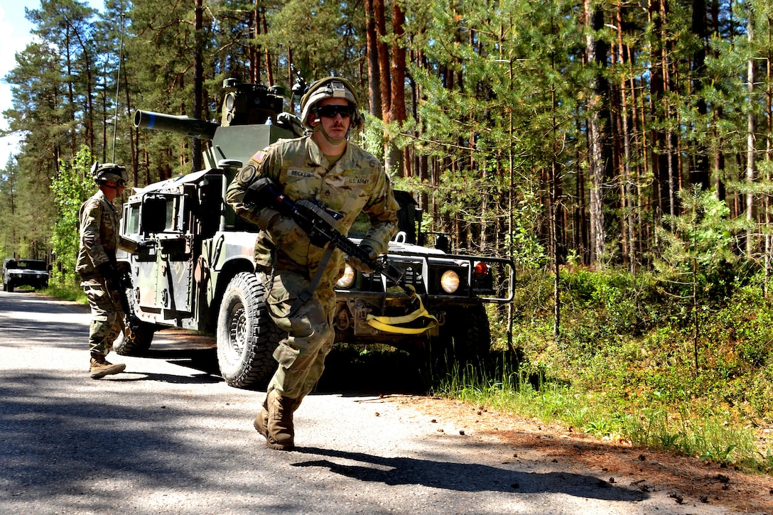 An Army National Guard soldier runs down a road.
