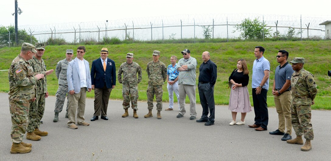 Local warfighters and Defense Logistics Agency personnel gather together at the new collection point on Camp Humphreys to celebrate its grand opening.