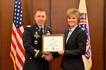 6th Medical Recruiting Battalion Commander, Lt. Col. Matthew Mapes, presents the PaYS certificate to Amy King, senior vice president and chief people manager, Centura Health, as part of ceremony to recognize the partnership at St. Anthony Hospital in Lakewood, Colo. on May 22, 2018.