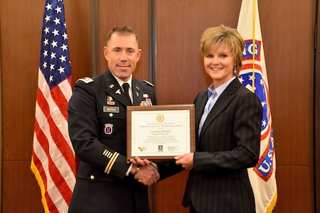 6th Medical Recruiting Battalion Commander, Lt. Col. Matthew Mapes, presents the PaYS certificate to Amy King, senior vice president and chief people manager, Centura Health, as part of ceremony to recognize the partnership at St. Anthony Hospital in Lakewood, Colo. on May 22, 2018.