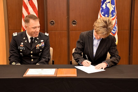 Senior Vice President and Chief People Manager for Centura Health, Amy King, signs the PaYS agreement during the ceremony to recognize the partnership at St. Anthony Hospital in Lakewood, Colo. on May 22, 2018.