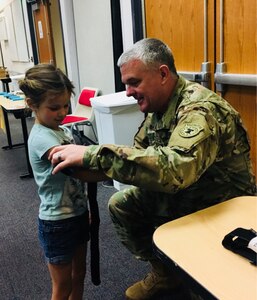 Major Michael Hay, officer-in-charge of the 6th Medical Recruiting Battalion’s Phoenix Medical Recruiting Station demonstrates why a tourniquet is not appropriate for small children using Harper Magoteaux’s arm. Hay and other medical professionals provided free public training at Maricopa Integrated Health System’s Auditorium as part of National Stop the Bleed Day on March 31.