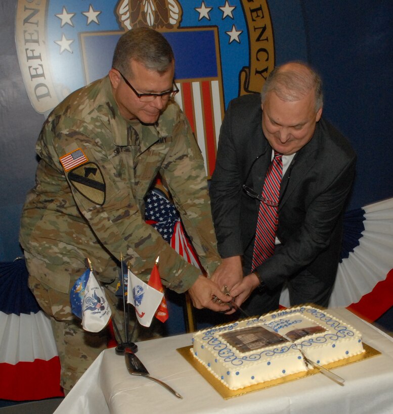 Defense Logistics Agency Troop Support Commander Army Brig. Gen. Mark Simerly (left) and Acquisition Executive William Kenny (right) cut Troop Support's birthday cake in Philadelphia July 6.