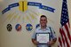 17th Training Group Student of the Month spotlight for June 2018, U.S. Air Force Airman 1st Class Nathan Collin, 316th TRS trainee, holds his award in front of a mural at Brandenburg Hall on Goodfellow Air Force Base, Texas, July 6, 2018. Collin is the Goodfellow Student of the Month spotlight for June 2018, a series highlighting Goodfellow students. (U.S. Air Force photo by Senior Airman Randall Moose/Released)
