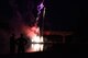 Attendees of the San Angelo Symphony Pops Concert watch as the fireworks are shot off from the Celebration Bridge at San Angelo Bill Aylor Sr. Memorial RiverStage, San Angelo, Texas, July 3, 2018. The concert included performances by the Community Band, Goodfellow Color Guard and a presentation of the 50 state flags. (U.S. Air Force photo by Airman 1st Class Seraiah Hines/Released)
