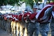 Goodfellow Air Force Base volunteers carry the flag to Chadbourne Street bridge in preparation for the 31st Annual San Angelo Symphony Pops Concert on July 3, 2018, at the Bill Aylor Sr. Memorial RiverStage, San Angelo, Texas. The flag was draped over the bridge while the symphony played ‘The Overture of 1812’ cannon fire from the Old Fort Concho cannon. (U.S. Air Force photo by Airman 1st Class Seraiah Hines/Released)
