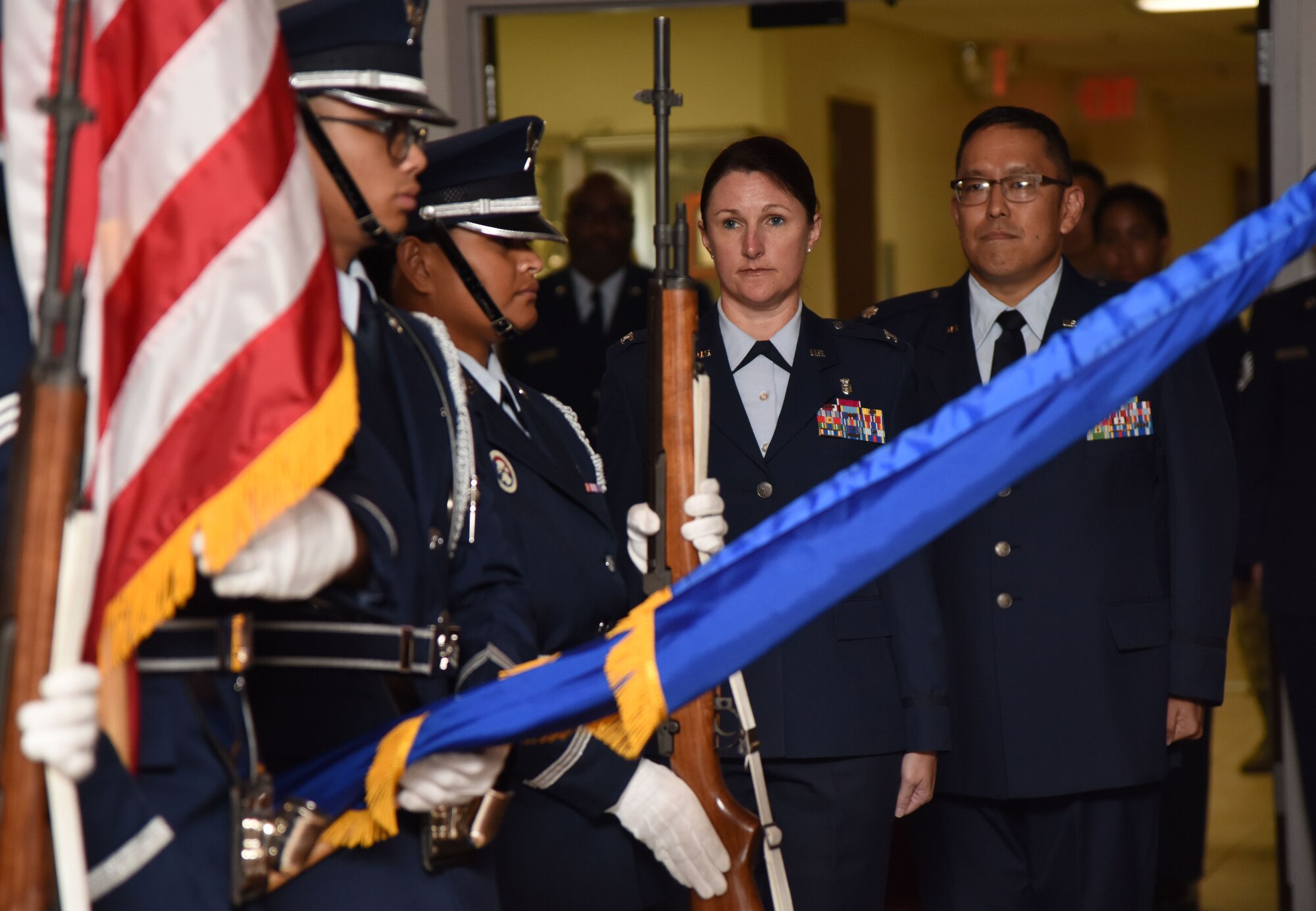 U.S. Air Force Col. Beatrice Dolihite, 81st Medical Group commander, and Lt. Col. Ryan Mihata, incoming 81st Surgical Operations Squadron commander, stand at attention during the 81st MSGS assumption of command ceremony at the Keesler Medical Center on Keesler Air Force Base, Mississippi, July 2, 2018. Mihata assumed command with the passing of a guidon, which is a ceremonial symbol of exchanging command from one commander to another. (U.S. Air Force photo by Kemberly Groue)