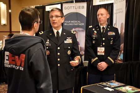 Brig. Gen. Joe Heck, Deputy Joint Staff Surgeon and Director, Reserve Readiness, and Capt. Nelson Kranz, Denver Medical Recruiting Company commander, speak to an attendee of the Essentials of Emergency Medicine workshop at the Cosmopolitan Hotel in Las Vegas on 15 May. Heck and Kranz were on hand with members of the 6th Medical Recruiting Battalion to explain the benefits and opportunities of a career in Army Medicine. For more information on the Army's more than 80 medical specialties, go online at healthcare.goarmy.com.