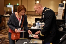 Capt. Nelson Kranz, Denver Medical Recruiting Company commander, hands out a brochure promoting Army health care to an attendee of the Essentials of Emergency Medicine workshop at the Cosmopolitan Hotel in Las Vegas on 15 May. Kranz was on hand with members of the 6th Medical Recruiting Battalion to explain the benefits and opportunities of a career in Army Medicine. For more information on the Army's more than 80 medical specialties, go online at healthcare.goarmy.com.