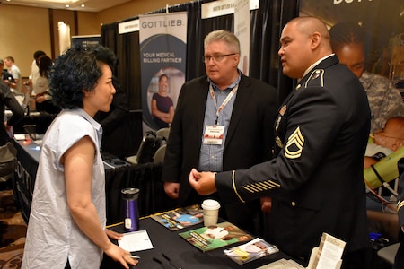 Sgt. 1st Class James Guevarra, U.S. Army health care recruiter with the Las Vegas Medical Recruiting Station, and Bruce Schamburek, education services specialist for 6th Medical Recruiting Battalion, speak to an attendee of the Essentials of Emergency Medicine workshop at the Cosmopolitan Hotel in Las Vegas on 15 May. Guevarra, Schamburek and other health care recruiters from the Denver Medical Recruiting Company, were on hand to explain the benefits and opportunities of a career in Army Medicine. For more information on the Army's more than 80 medical specialties, go online at healthcare.goarmy.com.