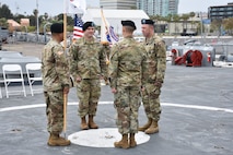 Lt. Col. Matthew Mapes, 6th Medical Recruiting Battalion commander, stands opposite the  outgoing and incoming company commanders and first sergeant for the Los Angeles Medical Recuiting Company Change of Command Ceremony on 11 May. The Los Angeles Medical Recruiting Company held their ceremony on the USS Iowa at the Port of Los Angeles and said farewell to Capt. Shawn Linhares while welcoming Capt. David O'hea as the incoming commander.
