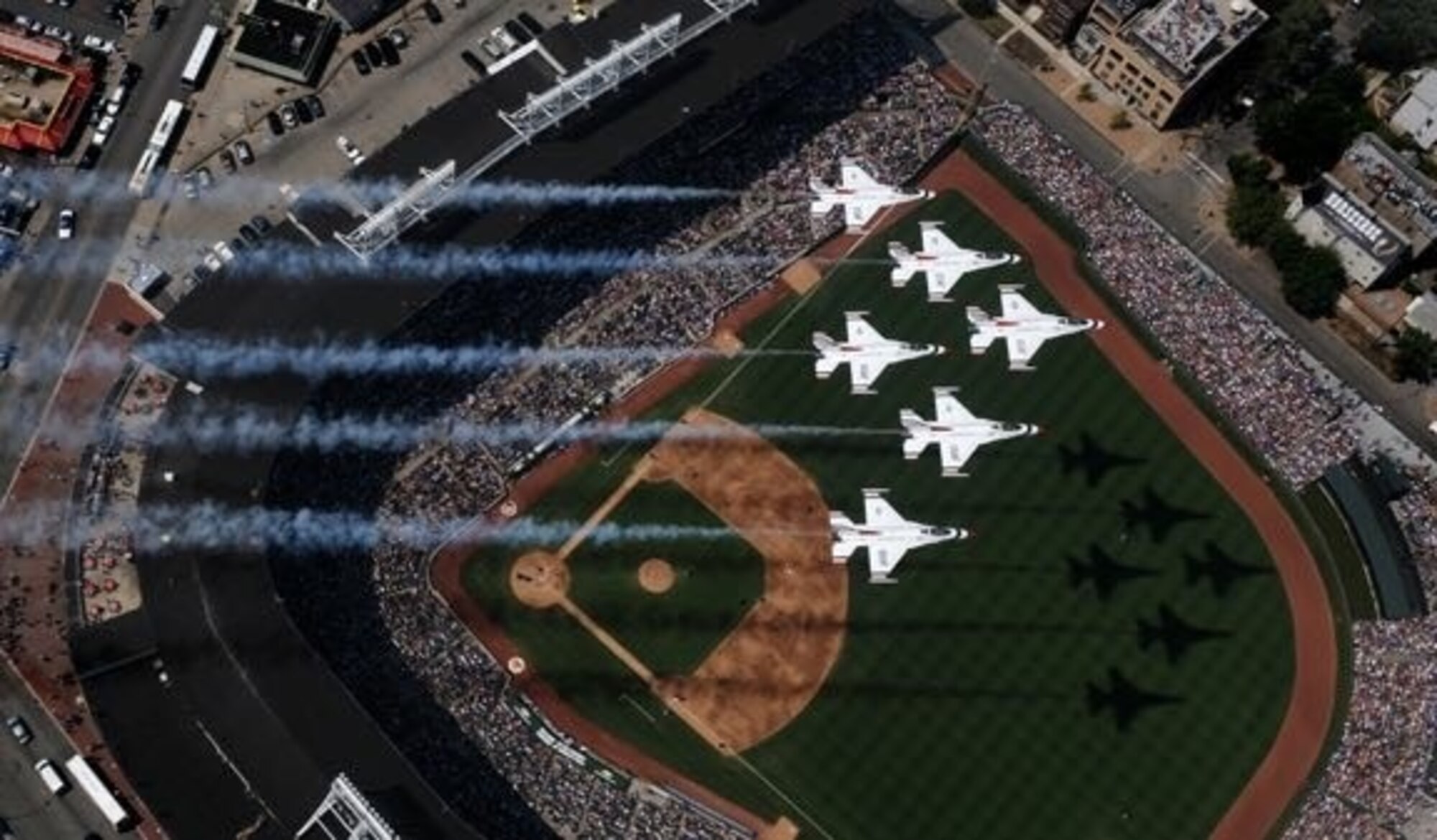 The U.S. Air Force Thunderbirds fly over Wrigley Field, prior to the start of their Friday practice for the Chicago Air and Water Show, 14 August 2009. The Thunderbirds represent the nearly 700,000 active duty, Air National Guard, Air Force Reserve and civilian Airmen serving in the United States and overseas. (U.S. Air Force photo by Capt. Kristi Machado)