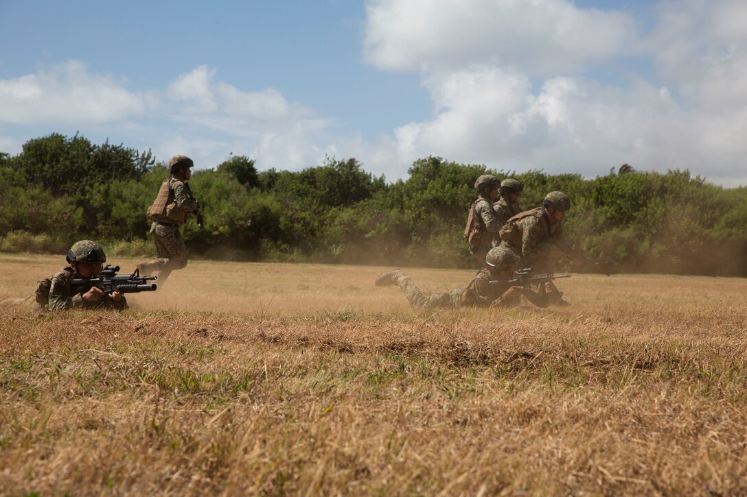 U.S. Marines with Company C, 1st Battalion, 3rd Marine Regiment, and Malaysian soldiers conduct buddy rushes during assault amphibious vehicle familiarization training as part of Rim of the Pacific (RIMPAC) exercise on Marine Corps Base Hawaii July 5, 2018. RIMPAC provides high-value training for task-organized, highly-capable Marine Air-Ground Task Force and enhances the critical crisis response capability of U.S. Marines in the Pacific. Twenty-five nations, 46 ships, five submarines, about 200 aircraft and 25,000 personnel are participating in RIMPAC from June 27 to Aug. 2 in and around the Hawaiian Islands and Southern California.  (U.S. Marine Corps photo by Lance Cpl. Thomas P. Miller)