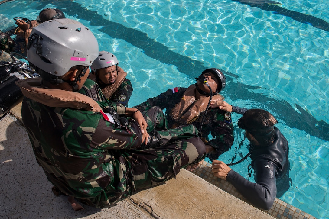 An Indonesian Marine surfaces from the water during shallow water egress training as part of Rim of the Pacific (RIMPAC) exercise at Marine Corps Base Hawaii July 5, 2018. RIMPAC provides high-value training for task-organized, highly-capable Marine Air-Ground Task Force and enhances the critical crisis response capability of U.S. Marines in the Pacific. Twenty-five nations, 46 ships, five submarines, about 200 aircraft and 25,000 personnel are participating in RIMPAC from June 27 to Aug. 2 in and around the Hawaiian Islands and Southern California.  (U.S. Marine Corps photo by Lance Cpl. Adam Montera)