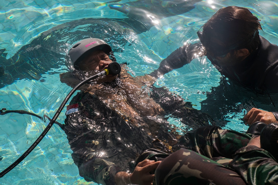An Indonesian surfaces from the water during shallow water egress training as part of Rim of the Pacific (RIMPAC) exercise at Marine Corps Base Hawaii July 5, 2018. RIMPAC provides high-value training for task-organized, highly-capable Marine Air-Ground Task Force and enhances the critical crisis response capability of U.S. Marines in the Pacific. Twenty-five nations, 46 ships, five submarines, about 200 aircraft and 25,000 personnel are participating in RIMPAC from June 27 to Aug. 2 in and around the Hawaiian Islands and Southern California. (U.S. Marine Corps photo by Lance Cpl. Adam Montera)