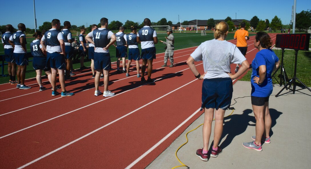 At far right, new 932nd Airlift Wing Command Chief Master Sgt. Barbara Gilmore, observes the starter's preparation for a 1.5 miles fitness test with a group of Illinois reservists.   Gilmore hopped in as a volunteer to help pace her Airmen and run alongside while giving them audible encouragement July 7, 2018, at Scott Air Force Base, Ill.  (U.S. Air Force photo by Lt. Col. Stan Paregien)
