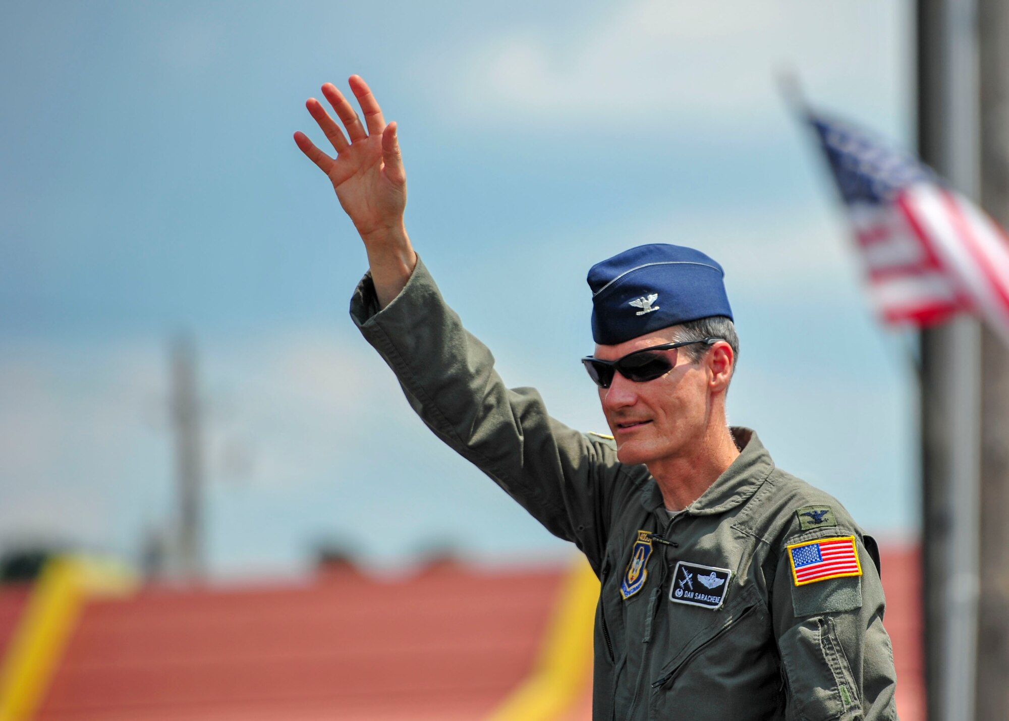 Col. Dan Sarachene, 910th Airlift Wing commander, waves to the crowd during a Fourth of July parade in Austintown, Ohio.