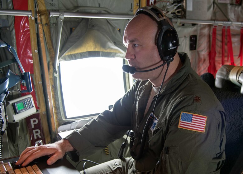 Maj. Ryan Rickert, 53rd Weather Reconnaissance Squadron aerial reconnaissance weather officer, reviews data gathered during Tropical Storm Chris July 8, 2018. This information is sent to the National Hurricane Center for use in their forecasts and advisories. (U.S. Air Force photo/Maj. Marnee A.C. Losurdo)