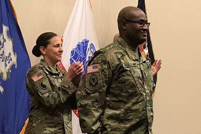 A man stands at his commissioning ceremony.