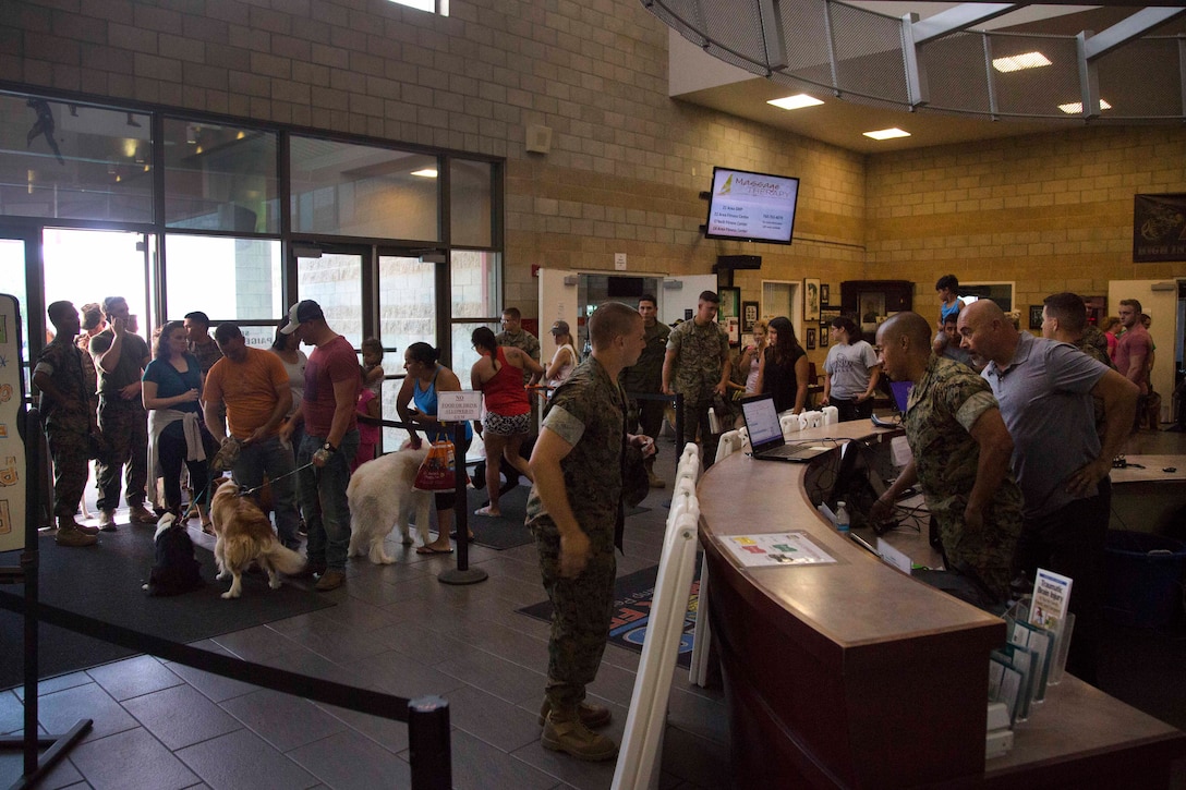 Marines and spouses check into the temporary evacuation control center.