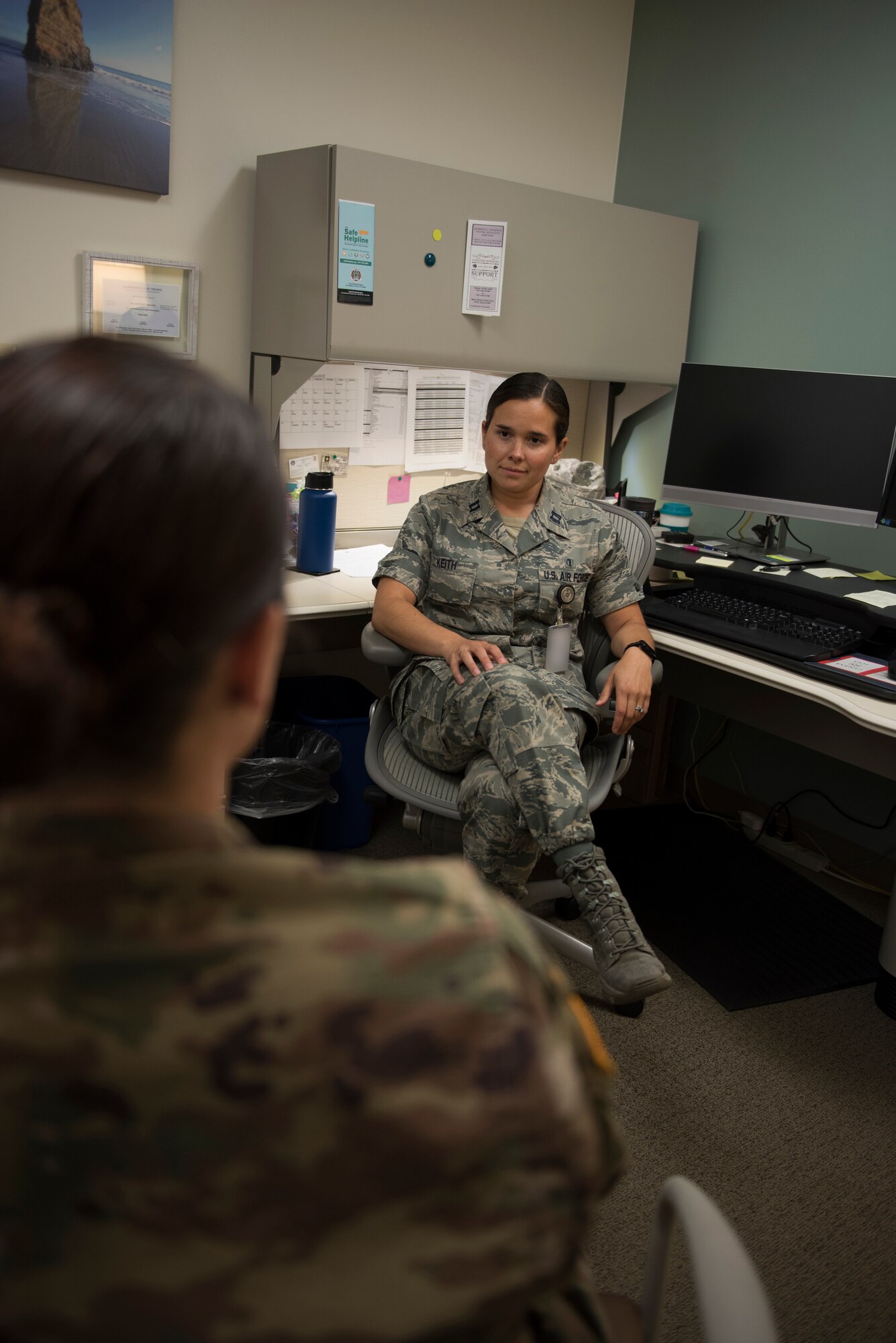 Capt. Felicia Keith, 60th Medical Operations Squadron director of psychological health, listens to one of her patients during a treatment session at David Grant USAF Medical Center at Travis Air Force Base, Calif., June 25, 2018. Keith and her team of professionals have treated more than 200 people who displayed post-traumatic stress symptoms over the past year. Badge blurred for security reasons. (U.S. Air Force photo by Tech. Sgt. James Hodgman)