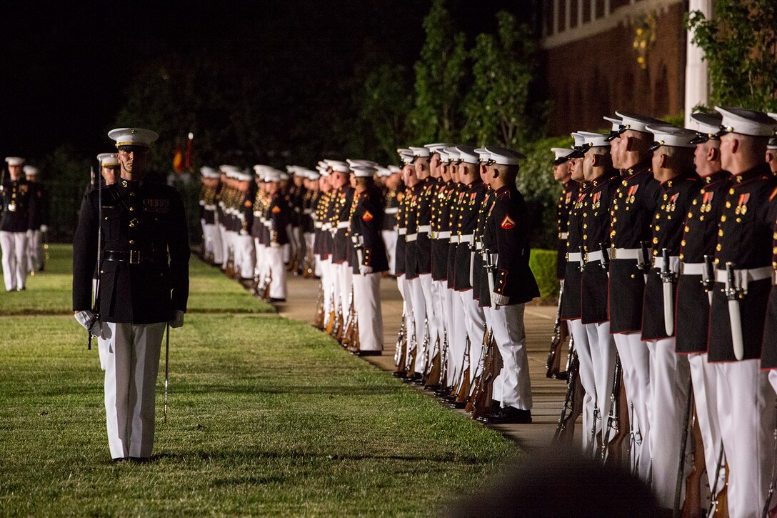 Marines with Alpha and Bravo Companies, Marine Barracks Washington D.C., cover and align during a Friday Evening Parade at Marine Barracks Washington D.C., July 6, 2018. The guests of honor for the parade were His Excellency Ambassador Virachai Plasai, ambassador of the Kingdom of Thailand to the U.S., and Minister Patrick A. Chuasoto, deputy chief of Mission, Embassy of the Republic of the Philippines to the U.S. The hosting official for the parade was Lt. Gen. Steven R. Rudder, deputy commandant of Aviation. (Official Marine Corps photo by Sgt. Robert Knapp/Released)
