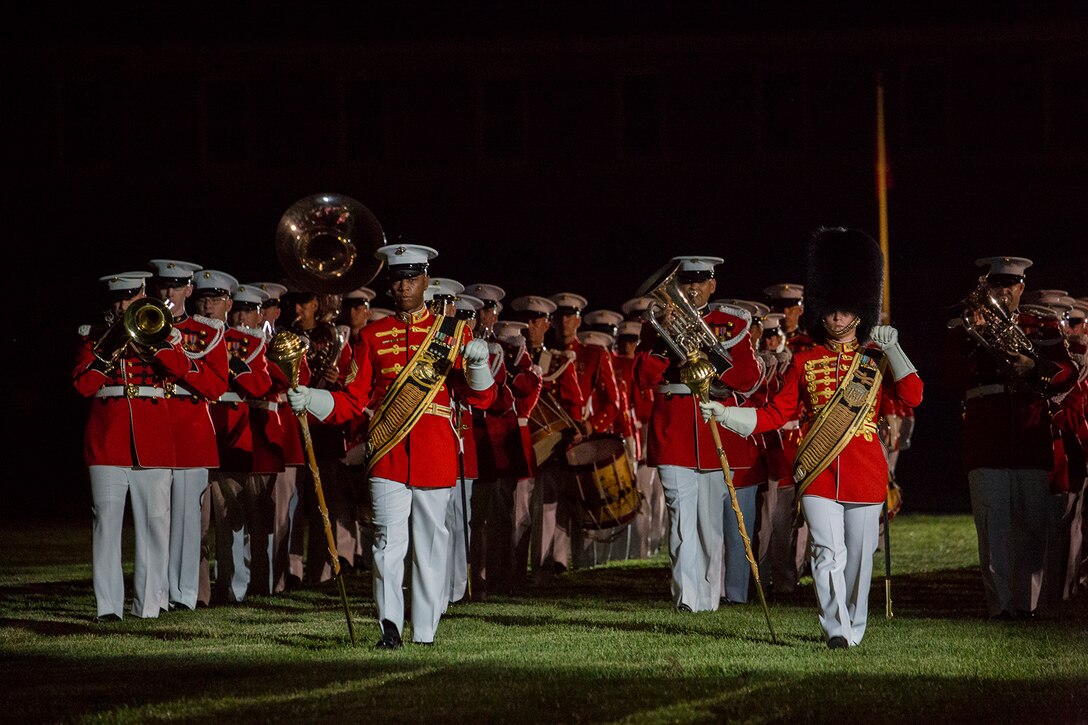 Master Gunnery Sgt. Kevin Buckles, left, drum major, “The Commandant’s Own,” U.S. Marine Drum & Bugle Corps,  and Gunnery Sgt. Stacie Crowther., right, assistant drum major, “The President’s Own” U.S. Marine Band, march across the parade deck during a Friday Evening Parade at Marine Barracks Washington D.C., July 6, 2018. The guests of honor for the parade were His Excellency Ambassador Virachai Plasai, ambassador of the Kingdom of Thailand to the U.S., and Minister Patrick A. Chuasoto, deputy chief of Mission, Embassy of the Republic of the Philippines to the U.S. The hosting official of the parade was Lt. Gen. Steven R. Rudder, deputy commandant of Aviation. (Official Marine Corps photo by Sgt. Robert Knapp/Released)