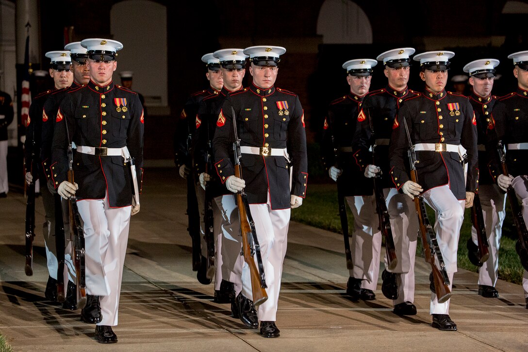 Marines with U.S. Marine Corps Silent Drill Platoon march on the parade deck during a Friday Evening Parade at Marine Barracks Washington D.C., July 6, 2018. The guests of honor for the parade were His Excellency Ambassador Virachai Plasai, ambassador of the Kingdom of Thailand to the U.S., and Minister Patrick A. Chuasoto, deputy chief of Mission, Embassy of the Republic of the Philippines to the U.S. The hosting official of the parade was Lt. Gen. Steven R. Rudder, deputy commandant of Aviation. (Official Marine Corps photo by Sgt. Robert Knapp/Released)
