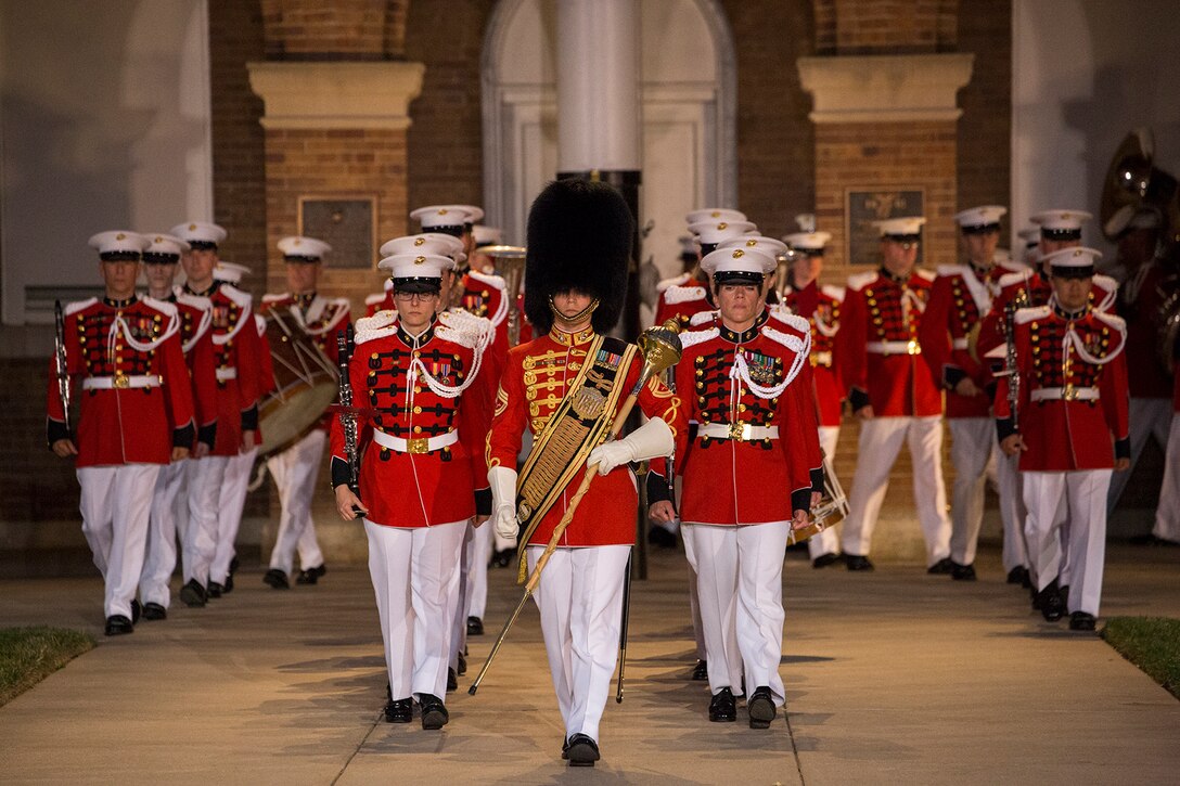 Gunnery Sgt. Stacie Crowther, assistant drum major, “The President’s Own” U.S. Marine Band, marches the band down Center Walk during a Friday Evening Parade at Marine Barracks Washington D.C., July 6, 2018. The guests of honor for the parade were His Excellency Ambassador Virachai Plasai, ambassador of the Kingdom of Thailand to the U.S., and Minister Patrick A. Chuasoto, deputy chief of Mission, Embassy of the Republic of the Philippines to the U.S. The hosting official of the parade was Lt. Gen. Steven R. Rudder, deputy commandant of Aviation. (Official Marine Corps photo by Sgt. Robert Knapp/Released)
