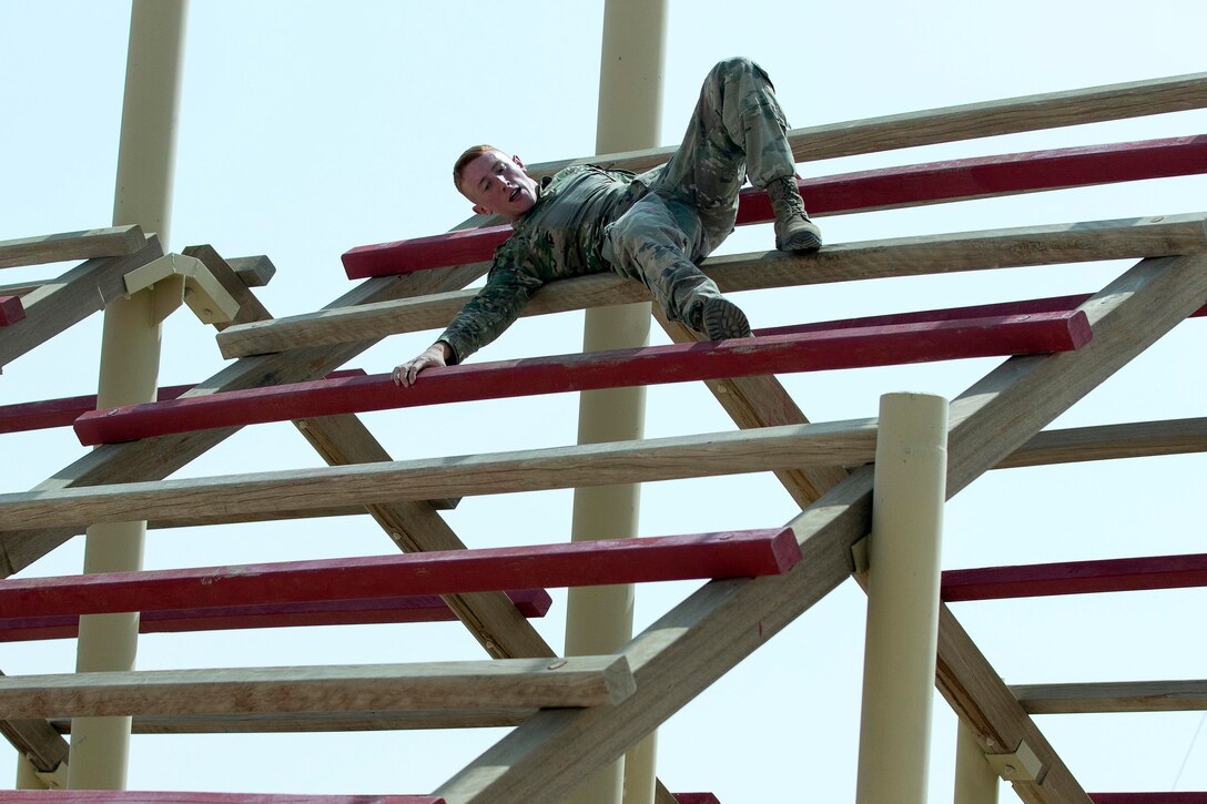 A soldier navigates through a weaver obstacle.