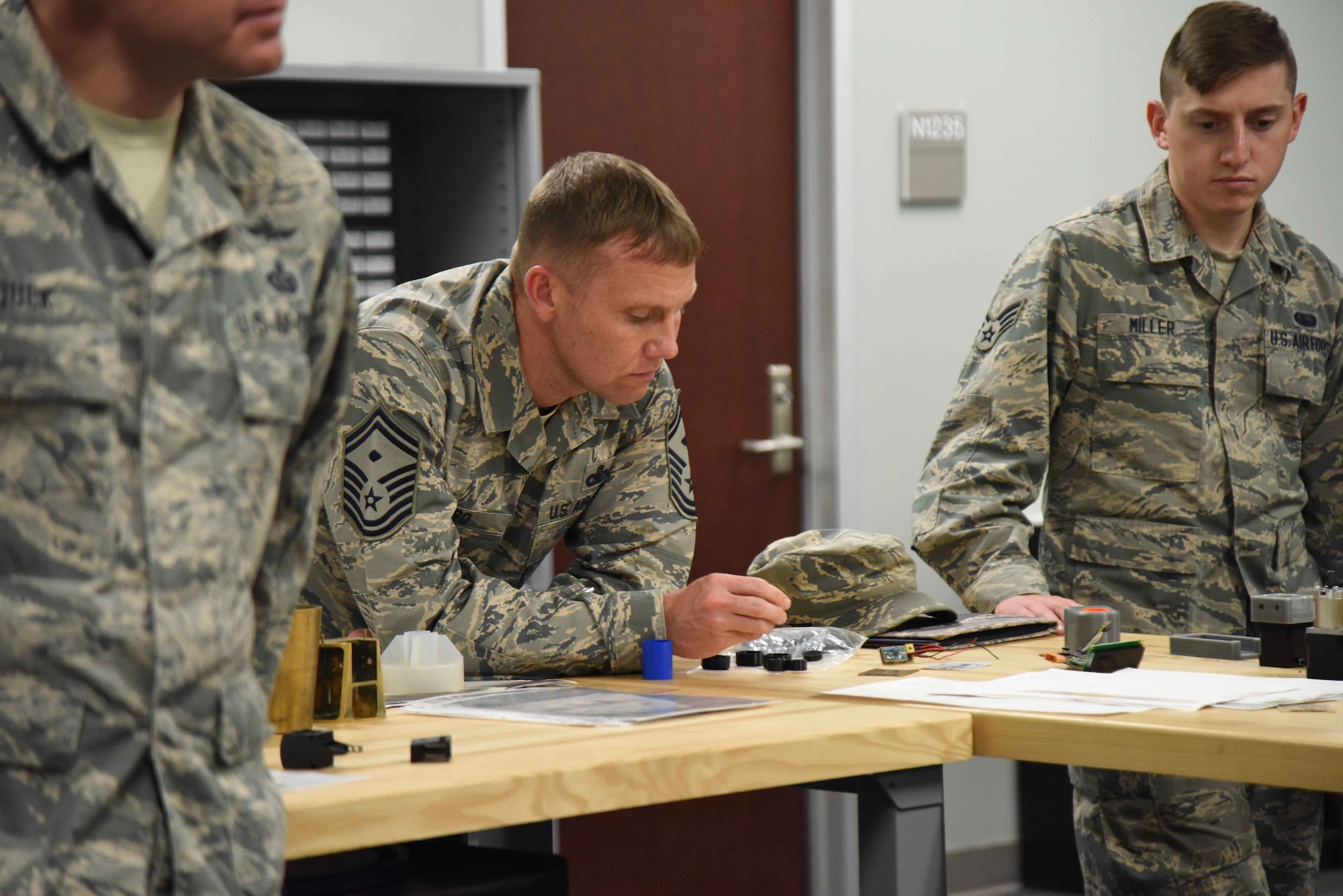 Senior Master Sgt. Scott Gero, a first sergeant at the 363rd Intelligence, Surveillance and Reconnaissance Wing, Langley AFB, Va., looks over some projects produced by members of the Air Force Technical Applications Center's Innovation Lab during a visit June 1, 2018.  Gero, along with 35 other Airmen across the Air Force ISR enterprise, visited the nuclear treaty monitoring center at Patrick AFB, Fla., to learn more about how AFTAC employs innovation to improve mission accomplishment.   (U.S. Air Force photo by Susan A. Romano)