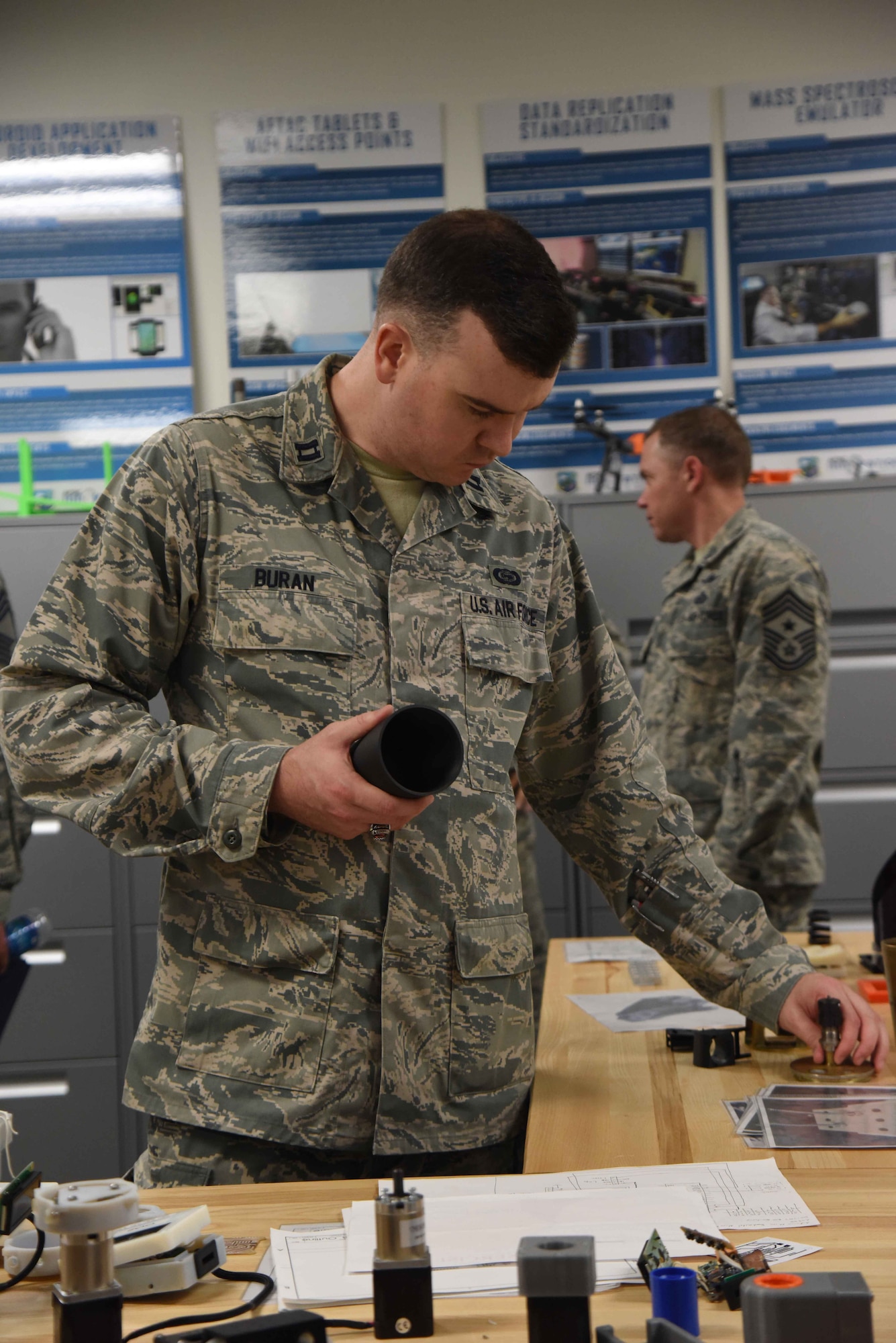 Capt. Corey Buran, an assistant director of operations at the 363rd Intelligence, Surveillance and Reconnaissance Wing, Langley AFB, Va., examines some projects produced by members of the Air Force Technical Applications Center's Innovation Lab during a visit June 1, 2018.  Buran was one of 35 Airmen within the ISR community to visit the nuclear treaty monitoring center at Patrick AFB, Fla., to learn more about how AFTAC employs innovation to improve its processes.   (U.S. Air Force photo by Susan A. Romano)
