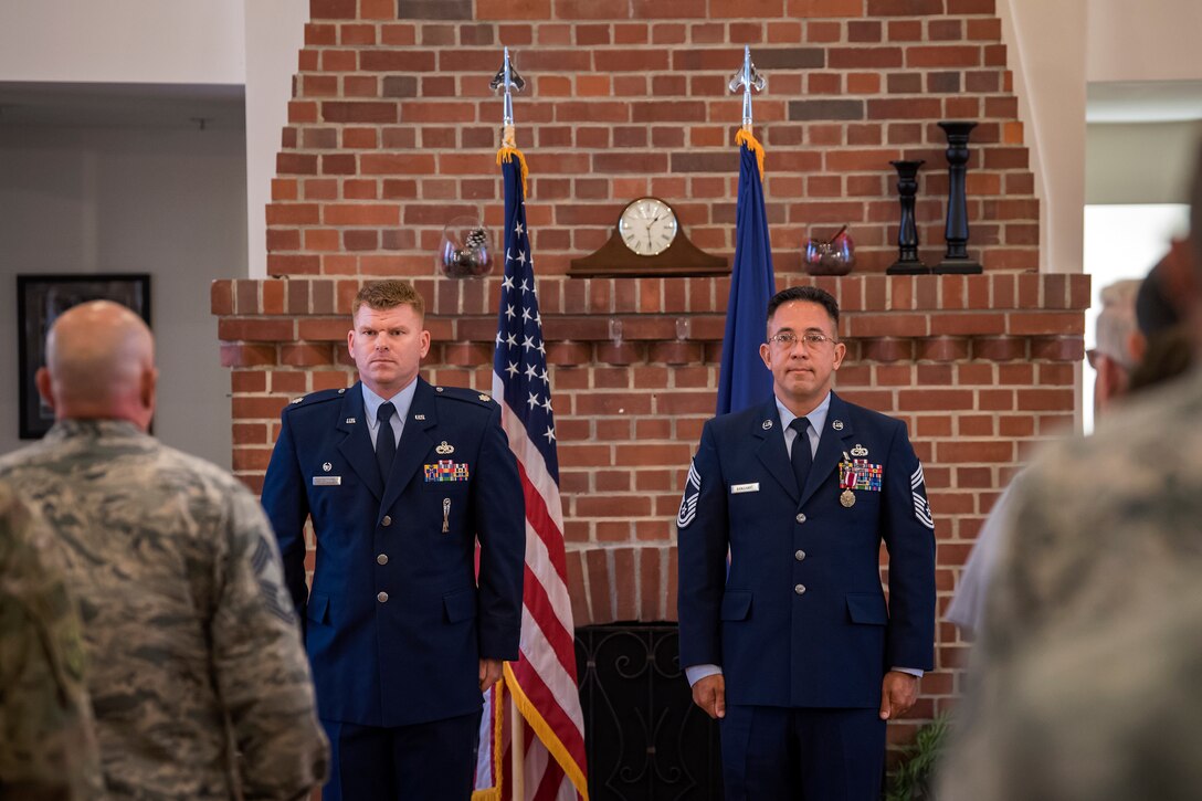 Chief Master Sgt. Jay Banghart, 23d Maintenance Squadron operations chief, right, stands at attention after receiving a Meritorious Service Medal, July 6, 2018, at Moody Air Force Base, Ga. Banghart entered the Air Force in 1990 and served in numerous positions within the aircraft maintenance career field throughout his 28 year Air Force career. (U.S. Air Force photo by Airman 1st Class Eugene Oliver)