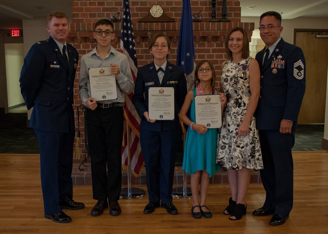 Lt. Col. Neal Van Houten, left , 23d Maintenance Squadron (MXS) commander, presents certificates of appreciation to the family of Chief Master Sgt. Jay Banghart’s, 23d MXS operations chief, during a retirement ceremony, July 6, 2018, at Moody Air Force Base, Ga. Banghart retired after serving 28 years in the Air Force in numerous positions within the aircraft maintenance career field. (U.S. Air Force photo by Airman Taryn Butler)