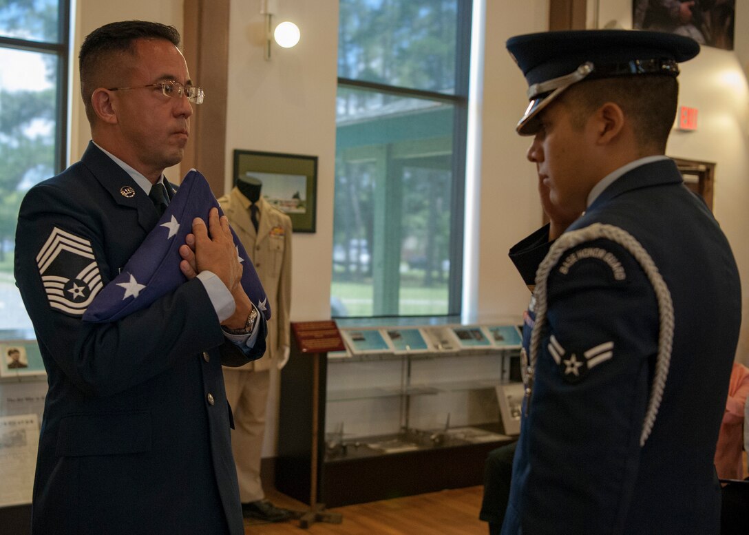 Chief Master Sgt. Jay Banghart, 23d Maintenance Squadron operations chief, receives a flag from a Moody honor guardsman during a retirement ceremony, July 6, 2018, at Moody Air Force Base, Ga. Banghart retired after serving 28 years in the Air Force in numerous positions within the aircraft maintenance career field. (U.S. Air Force photo by Airman Taryn Butler)