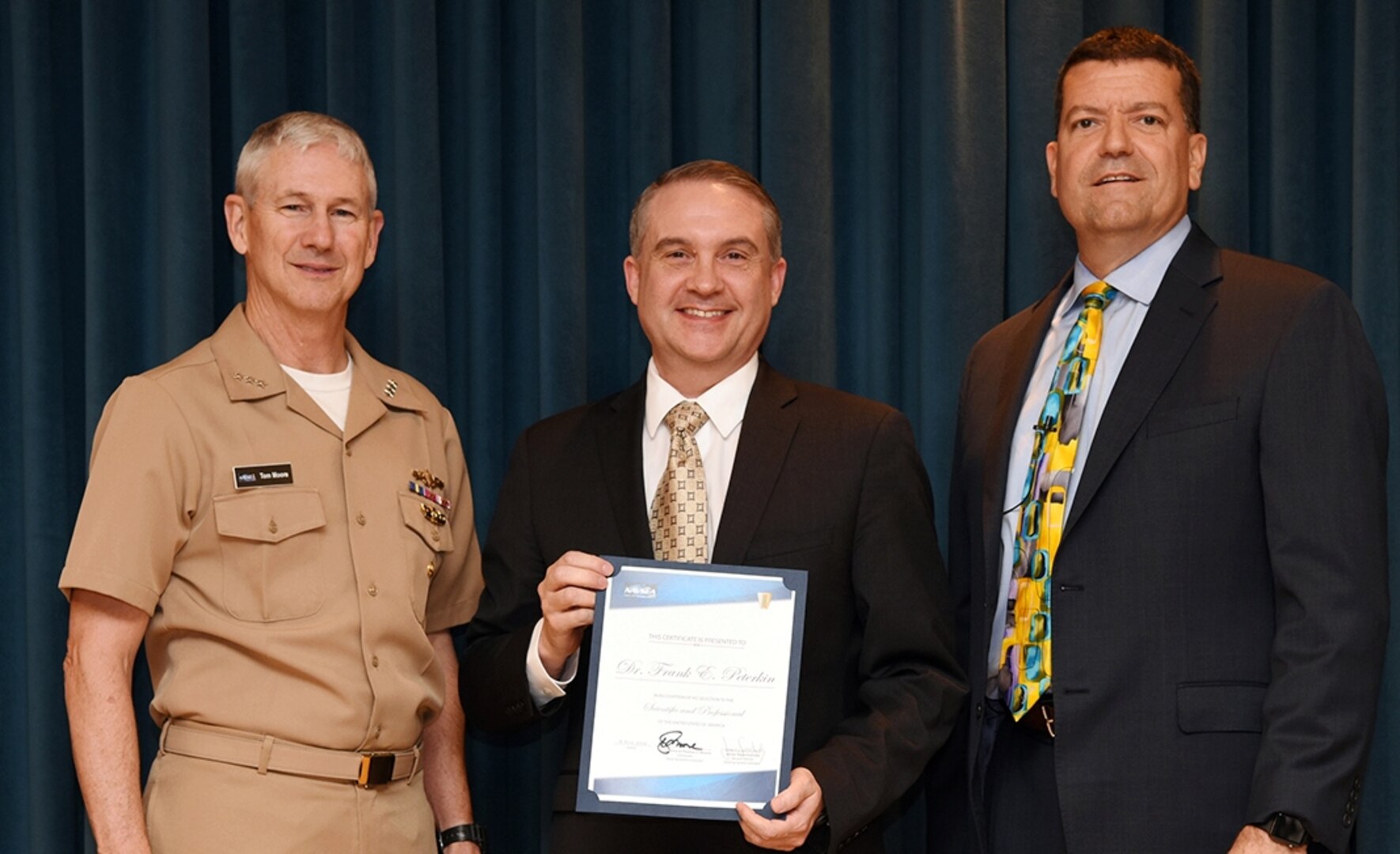 IMAGE: Vice Adm. Thomas Moore, commander of Naval Sea Systems Command (NAVSEA), and James Smerchansky, NAVSEA Executive Director, presented the Scientific and Professional Executive Award to NSWCDD engineer Dr. Frank Peterkin at a NAVSEA headquarters ceremony, June 18. 

As the Navy's Distinguished Engineer for Directed Energy, Peterkin is responsible for assessing directed energy efforts across the Navy, technology development, and warfighting applications and for providing strategic direction in the development of directed energy capabilities. Peterkin is the driving technical force behind the Navy Laser Family of Systems which will result in the fielding of lasers onto surface ships.
