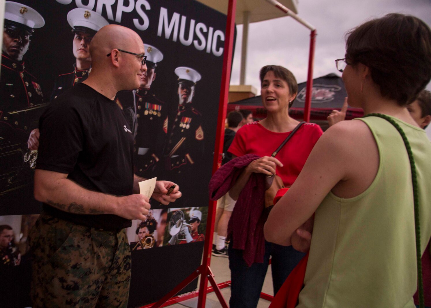 Gunnery Sergeant Matthew R. Phagan, the Music Technical Assistant with 6th Marine Corps District, speaks to attendees of the Drum Corps International at River Bluff High School in Lexington, South Carolina, July 07, 2018. The Drum Corps International creates a stage for the Marine Corps to engage in education, competition, and the promotion of individual growth. (U.S. Marine Corps photo by Lance Cpl. Jack A. E. Rigsby)