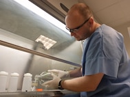 IMAGE: DAHLGREN, Va. - Dr. Tony Buhr, senior Naval Surface Warfare Center Dahlgren Division (NSWCDD) biologist, measures reagents for spore preparations in a biosafety cabinet at the NSWCDD Biosafety Level 2 Laboratory in this undated photo. Buhr received the 2017 Dr. Delores M. Etter Top Scientists and Engineers Award for Individual Engineers at a June 29, 2018 Pentagon ceremony in recognition of his contributions to the Navy's chemical, biological and radiological defense. Specifically, he was honored for his work in developing a new and highly reliable testing regimen for evaluating effectiveness in biological defenses, increasing the confidence level of those defenses up to 95 percent.  (U.S. Navy photo/Released)