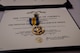 Medal resting on a certificate.
