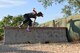 U.S. Army Pfc. Breanna Dagen, 344th Military Intelligence Battalion trainee, jumps over a barrier during the 344th MI BN mud run at the Camp Sentinel training area on Goodfellow Air Force Base, Texas, July 7, 2018. Out of the fifteen competitors at the event, Dagen was the only female who entered.  (U.S. Air Force photo by Staff Sgt. Joshua Edwards/Released)