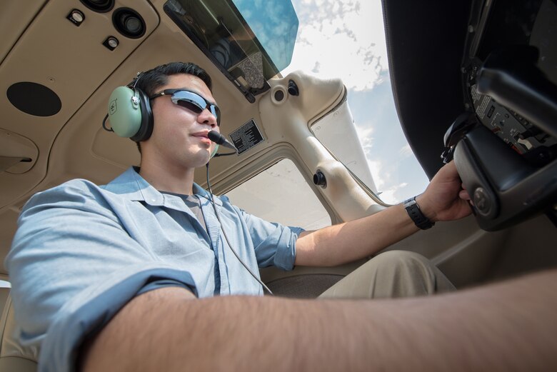 Cadet James Huang, North Gwinnett High School, Suwanee, Georgia, sits in the cockpit of a trainer aircraft at Auburn University, Alabama. Huang is one of 120 cadets selected for a Flight Academy scholarship by Air Force Junior ROTC. The Chief of Staff of the Air Force Flight Academy scholarship program allows selected Air Force Junior ROTC cadets to attend an accredited aviation program at one of six partnering universities to get a private pilot license. (U.S. Air Force photo by Airman Matthew Markivee)
