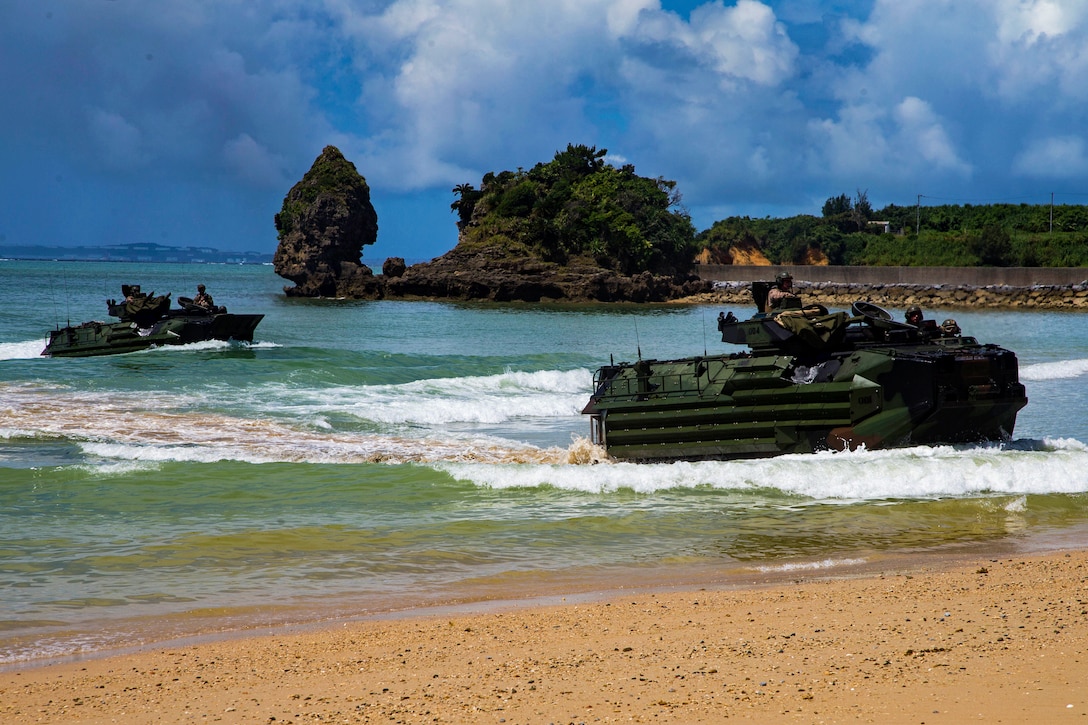 Marines in assault amphibious vehicles come ashore.