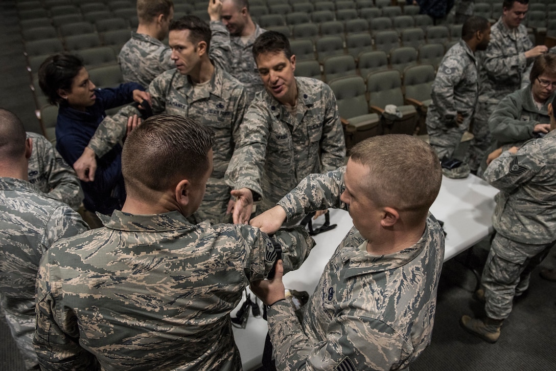 Service members practice tourniquet placement and application.